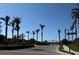 Gated community entrance with palm trees lining the drive, ensuring privacy and curb appeal at 413 Wildlife Gln, Bradenton, FL 34209