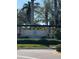 Elegant entrance sign for The Estuary community, framed by lush landscaping and mature palm trees at 413 Wildlife Gln, Bradenton, FL 34209