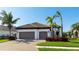 Two-car garage and attractive landscaping enhance this home's curb appeal at 413 Wildlife Gln, Bradenton, FL 34209