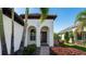 Front entrance with arched entryway, landscaping and walkway at 413 Wildlife Gln, Bradenton, FL 34209