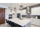 Elegant kitchen boasting white cabinets, quartz countertops, and a large island at 413 Wildlife Gln, Bradenton, FL 34209