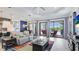 Bright living room with recessed lighting, large TV, and sliding doors leading to the pool at 413 Wildlife Gln, Bradenton, FL 34209