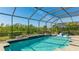 Large screened pool with patio and lush landscaping at 413 Wildlife Gln, Bradenton, FL 34209