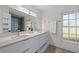 Modern bathroom with double vanity, quartz countertops and glass-block shower at 416 Giovanni Dr, Nokomis, FL 34275