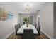 Bright dining room featuring a large table with seating for six and a modern chandelier at 416 Giovanni Dr, Nokomis, FL 34275