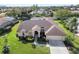 Single-Gathering home with a brown roof and landscaped yard at 4901 Fallcrest Cir, Sarasota, FL 34233