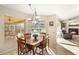 Bright breakfast nook with wooden table and chairs, overlooking the pool at 4901 Fallcrest Cir, Sarasota, FL 34233