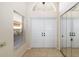 Bright entryway with double doors and mirrored closets at 4901 Fallcrest Cir, Sarasota, FL 34233