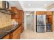 Modern kitchen with stainless steel appliances and wood cabinets at 4901 Fallcrest Cir, Sarasota, FL 34233