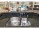 Double stainless steel sink with modern faucet, and granite countertop at 4901 Fallcrest Cir, Sarasota, FL 34233