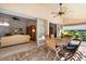 Outdoor patio with wooden table and chairs, adjacent to living room at 4901 Fallcrest Cir, Sarasota, FL 34233