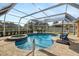 Inviting kidney-shaped pool with spa and screened enclosure at 4901 Fallcrest Cir, Sarasota, FL 34233