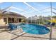 Relaxing pool area with patio furniture and screened enclosure at 4901 Fallcrest Cir, Sarasota, FL 34233