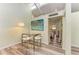 Bright dining area with glass-top table and white chairs, near the kitchen at 500 N Jefferson Ave # C3, Sarasota, FL 34237