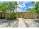 Attractive front yard with walkway, wooden fence, and lush landscaping at 500 N Jefferson Ave # C3, Sarasota, FL 34237