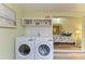 Clean laundry room with stacked washer and dryer, plus a view into bedroom at 500 N Jefferson Ave # C3, Sarasota, FL 34237