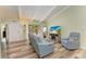 Bright living room with light gray couch, recliner, and wood-look flooring at 500 N Jefferson Ave # C3, Sarasota, FL 34237