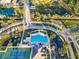 Aerial view of a community clubhouse, pool, playground, tennis courts, and basketball courts at 5001 65Th E Ter, Ellenton, FL 34222