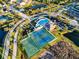 Aerial view of a community clubhouse featuring a pool, playground, tennis courts, and basketball courts at 5001 65Th E Ter, Ellenton, FL 34222