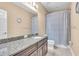 Bathroom featuring granite countertops, shower with patterned curtain and ample counter space at 5001 65Th E Ter, Ellenton, FL 34222