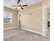 This carpeted bedroom has a ceiling fan and views to the outside at 5001 65Th E Ter, Ellenton, FL 34222