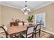 Inviting dining room with a classic chandelier and a view of the outdoor landscape at 5001 65Th E Ter, Ellenton, FL 34222