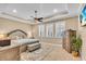 Serene bedroom featuring a tray ceiling, a ceiling fan, three windows, and neutral tones with a large bed at 5001 65Th E Ter, Ellenton, FL 34222