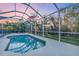 Private screened-in pool with a sunset sky and lush landscaping beyond at 5001 65Th E Ter, Ellenton, FL 34222