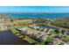 Expansive aerial view showcasing a residential area nestled along the coast and serene lakes at 508 Wildlife Gln, Bradenton, FL 34209