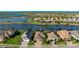 Aerial view of a home with a tile roof surrounded by lakes and other real estate properties at 508 Wildlife Gln, Bradenton, FL 34209