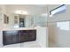 Modern bathroom featuring double vanities, sleek fixtures, and a spacious walk-in shower with glass enclosure at 508 Wildlife Gln, Bradenton, FL 34209