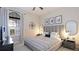 Modern bedroom featuring neutral color scheme and large bed, a television and dark wood window frame at 508 Wildlife Gln, Bradenton, FL 34209