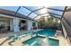 Inviting screened pool and spa area featuring a built-in grill, ideal for outdoor gatherings at 508 Wildlife Gln, Bradenton, FL 34209