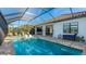 Backyard pool with a screened enclosure, tile patio, and an outdoor kitchen at 508 Wildlife Gln, Bradenton, FL 34209