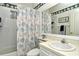 Bathroom with tub, shower, and seashell-themed curtain at 5150 Mahogany Run Ave, Sarasota, FL 34241