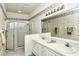 Bathroom boasts double sinks, a shower, and a large mirror at 5150 Mahogany Run Ave, Sarasota, FL 34241