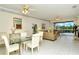 Open dining area with glass table and chairs, leading to the living room at 5150 Mahogany Run Ave, Sarasota, FL 34241