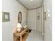 Bright entryway with tiled floor, console table, and framed artwork at 5150 Mahogany Run Ave, Sarasota, FL 34241