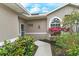 House exterior showing walkway to front door, surrounded by lush landscaping at 5150 Mahogany Run Ave, Sarasota, FL 34241