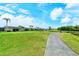 Golf course path with pond and homes in the background at 5150 Mahogany Run Ave, Sarasota, FL 34241