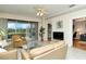 Spacious living room with tan leather sofas, glass coffee table, and view of the screened patio at 5150 Mahogany Run Ave, Sarasota, FL 34241