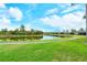 Scenic pond-side path with lush landscaping and homes at 5150 Mahogany Run Ave, Sarasota, FL 34241