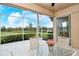 Enjoy serene views from this screened patio, featuring a table and chairs at 5150 Mahogany Run Ave, Sarasota, FL 34241