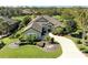 Aerial view of a single Gathering home with well-manicured lawn, mature trees, and golf course views at 5304 96Th E St, Bradenton, FL 34211