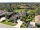 Aerial view of a single Gathering home with well-manicured lawn, mature trees, and golf course views at 5304 96Th E St, Bradenton, FL 34211