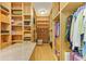 Large walk-in closet featuring custom shelves and shoe storage provides an organized space for clothes and accessories at 5304 96Th E St, Bradenton, FL 34211