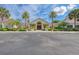 Clubhouse exterior features a portico entrance and mature palm tree landscaping at 5304 96Th E St, Bradenton, FL 34211