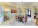 Elegant dining room with a decorative rug, chandelier, and seating for six, offering a warm and inviting atmosphere at 5304 96Th E St, Bradenton, FL 34211