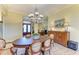 Elegant dining area showcasing a chandelier, ornate table setting, and traditional decor, exuding timeless charm at 5304 96Th E St, Bradenton, FL 34211