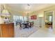 Charming dining room featuring a round table, chandelier, and large windows, creating a bright and airy space at 5304 96Th E St, Bradenton, FL 34211